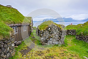 Aerial view of fishing village in Koltur island. Faroe Islands. Green roof houses. Photo made by drone from above. Nordic natural