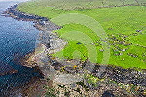 Aerial view of fishing village in Koltur island. Faroe Islands. Green roof houses. Photo made by drone from above. Nordic natural