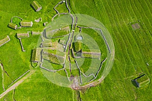 Aerial view of fishing village in Koltur island. Faroe Islands. Green roof houses. Photo made by drone from above. Nordic natural