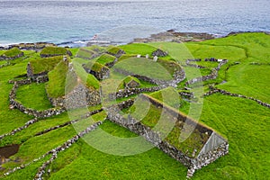 Aerial view of fishing village in Koltur island. Faroe Islands. Green roof houses. Photo made by drone from above. Nordic natural