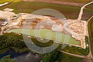 Aerial view of fishpond construction site from drone pov photo