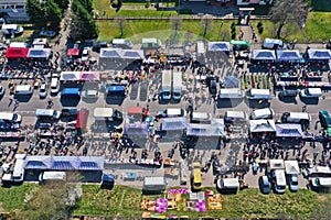 Aerial view on flea market with miscellaneous items and crowds of buyers and seller`s makeshift stands