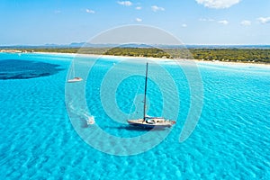 Aerial view of floating sailboat and motorboat in transparent sea