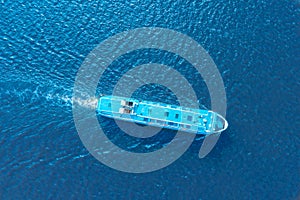 Aerial view of floating ship colorful landscape with boat in marina bay, blue sea. Top aerial view from drone of yacht