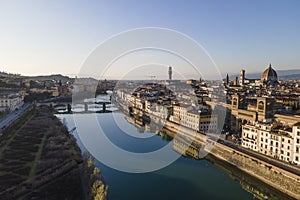 Aerial view of Florence skyline along Arno river with Ponte Vecchio and Santa Maria del Fiore church, Tuscany, Italy