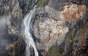 Aerial view of the flowing Voringsfossen waterfall in the rocky mountains of Norway