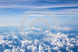 Aerial view of Fluffy clouds Top view from airplane window, Nature background