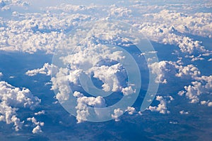 Aerial view of Fluffy clouds Top view from airplane window, Nature background