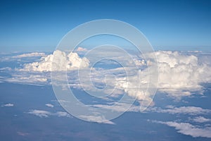 Aerial view of fluffy clouds. Top view of a beautiful cloudscape and blue sky