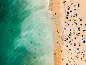 Aerial View From Flying Drone Of People Crowd Relaxing On Algarve Beach