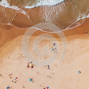 Aerial View From Flying Drone Of People Crowd Relaxing On Algarve Beach