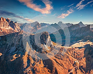 Aerial view from flying drone of winding Giau pass road with Ra Gusela peak.