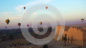 Aerial view flying through Medinet Habu temple from hot air balloon near Valley of the kings Luxor Egypt