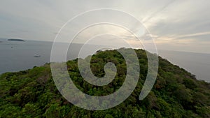 Aerial view flying mountain peak greenery vegetation picturesque sea landscape panorama cloudy sky