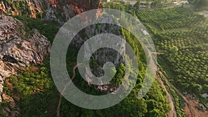 Aerial view flying orbit of Khao Kuha mountain hill at sunrise, Songkhla