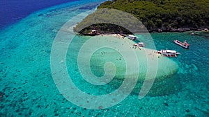 Aerial view flying over amazing of sandy beach clear sea water of the Sumilon island beach landing near Oslob, Cebu, Philippines.