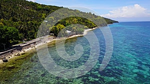 Aerial view flying over amazing of sandy beach with tourists swimming in beautiful clear sea water of the Sumilon island beach