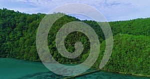 Aerial view flying over the beautiful and tropical green mountains Sugba Lagoon in Siargao, Philippines