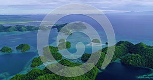 Aerial view flying over the beautiful and tropical green mountains Sugba Lagoon in Siargao, Philippines