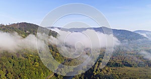 Aerial View. Flying over the high mountains in beautiful clouds . Aerial camera shot. Air clouds.