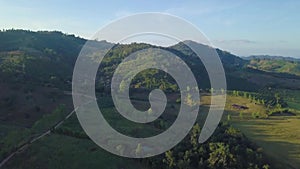 Aerial View, Flying over the mountains and trees with beautiful clouds and sky in sunrise