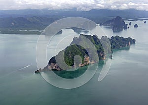 Aerial view flying over tropical green island group in Phang Nga Bay, Andaman Sea Thailand, seascape, green and blue