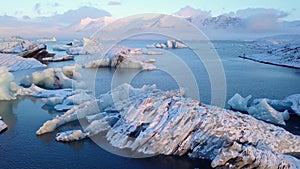 Aerial view flying pass over icebergs in Jokulsarlon glacier lagoon, Iceland