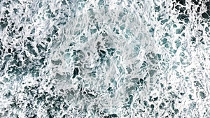 Aerial view of the foam, spray and turquoise sea water.View fro