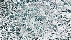Aerial view of the foam, spray and turquoise sea water.View fro