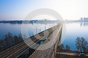 Aerial view of fog over Voronezh river and North Bridge with car traffic, drone shote from above, morning haze and cityscape