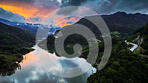 Aerial view of a foggy sunset over Siriu lake