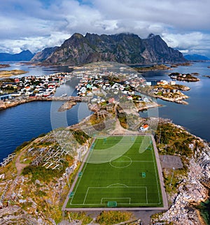 Aerial view of football field or soccer field in the Henningsvaer with mountains in the background. Lofoten Islands