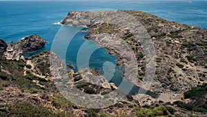 Aerial view of Fredosa cove rocky beach surrounded by emerald water in Cap de Creus photo