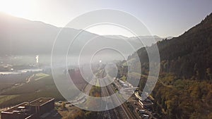 Aerial view of freeway interstate road in austrian alps with fast moving traffic and rural green landscape.