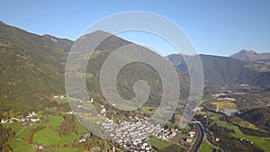 Aerial view of freeway interstate road in austrian alps with fast moving traffic and rural green landscape.