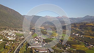 Aerial view of freeway interstate road in austrian alps with fast moving traffic and rural green landscape.