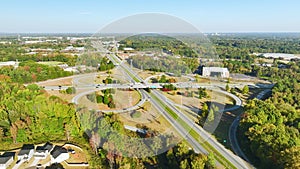 Aerial view of freeway overpass junction with fast moving traffic cars and trucks. Interstate transportation