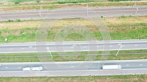 Aerial view of a freeway and railway. Clip. Highway and railway with cars and trucks, interchange, two-level road