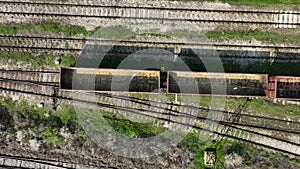 Aerial view of a freight train with empty containers. Empty wagons of a freight train. Rail transport concept