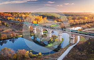 Aerial view of freight train on railroad bridge and river