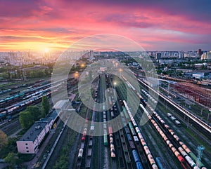 Aerial view of freight trains at colorful sunset. Railway station