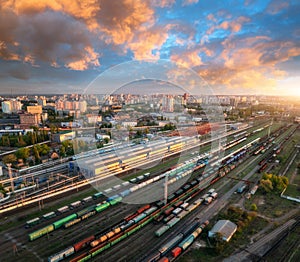 Aerial view of freight trains at sunset. Railway cargo wagons