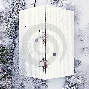 Aerial View of Freshly Snow-Covered Roof of a Small Single-Family House with Gable Roof in Germany