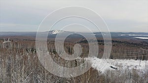 Aerial view of a frozen forest with snow covered trees at winter. Clip. Flight above mixed forest in Finland with