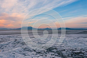 Aerial view about frozen lake Balaton with Badacsony and Gulacs at the background.