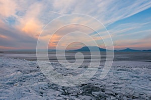 Aerial view about frozen lake Balaton with Badacsony and Gulacs at the background.