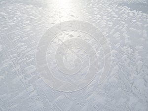 Aerial view of a frozen lake surface. Aerial Snow pattern on the frozen lake. Frozen lake ice captured with a drone. Aerial photo