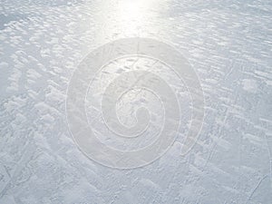 Aerial view of a frozen lake surface. Aerial Snow pattern on the frozen lake. Frozen lake ice captured with a drone. Aerial photo