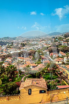 aerial view of Funchal city from cablecar - teleferico cabine on sunny winter day in february with a reflection