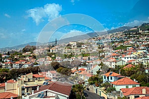 aerial view of Funchal city from cablecar - teleferico cabine on sunny winter day with a reflection in a window